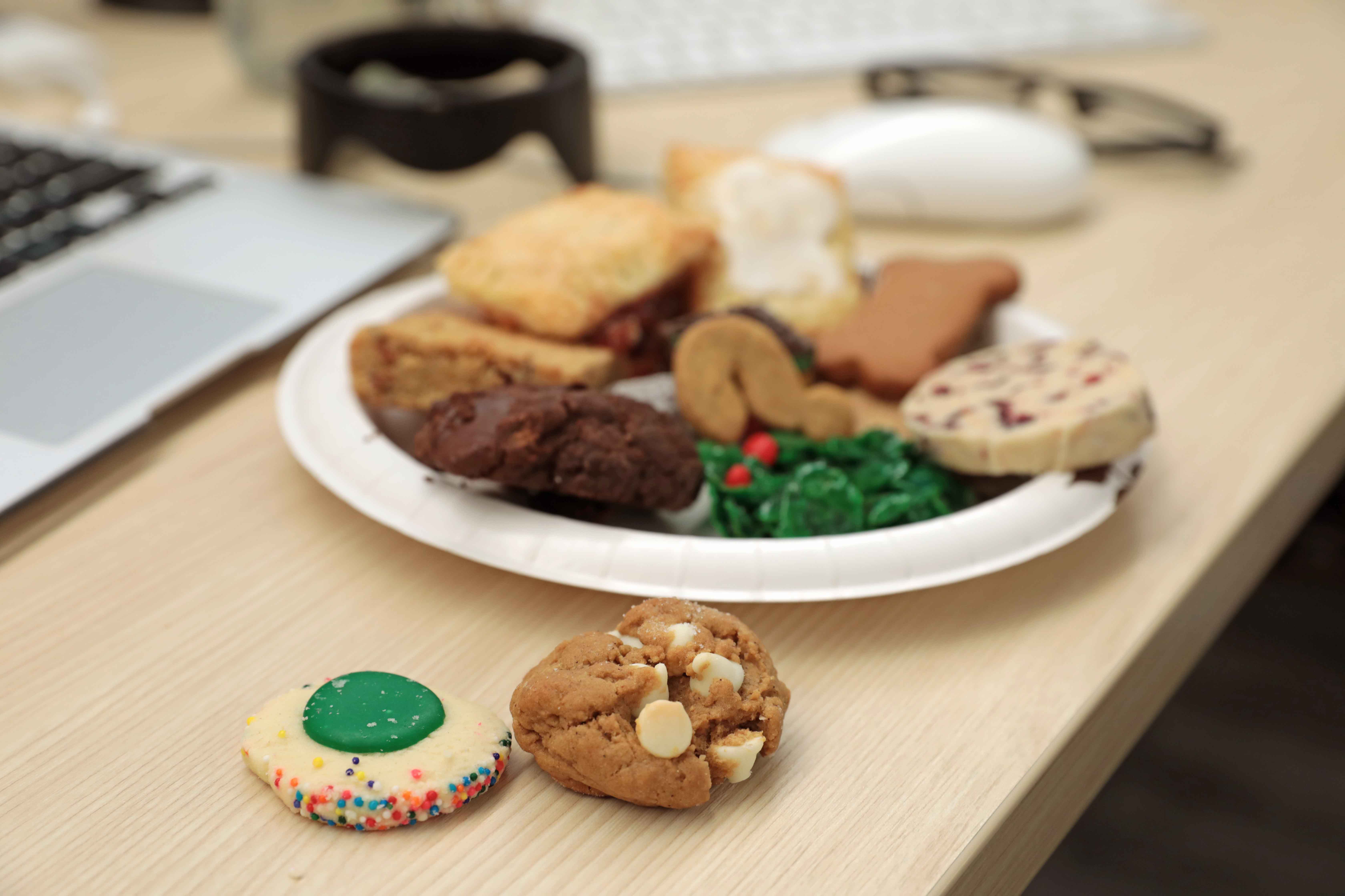 A plate of holiday cookies on a desk