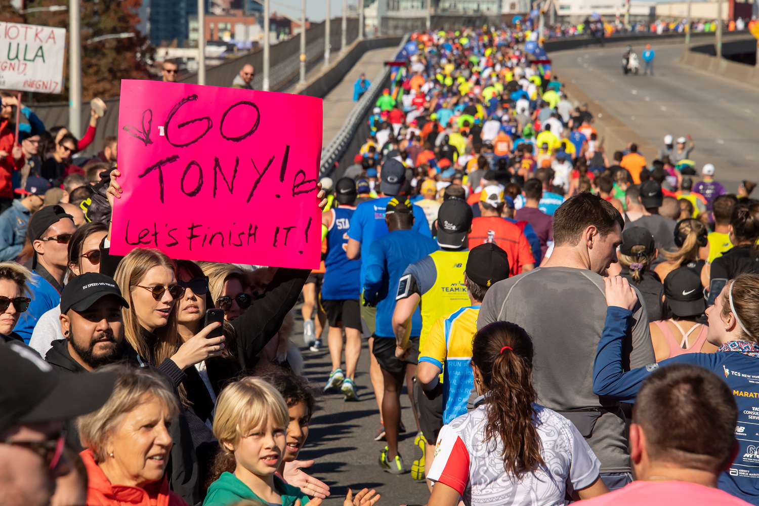 New York City Marathon runners receiving encouragement from spectators 